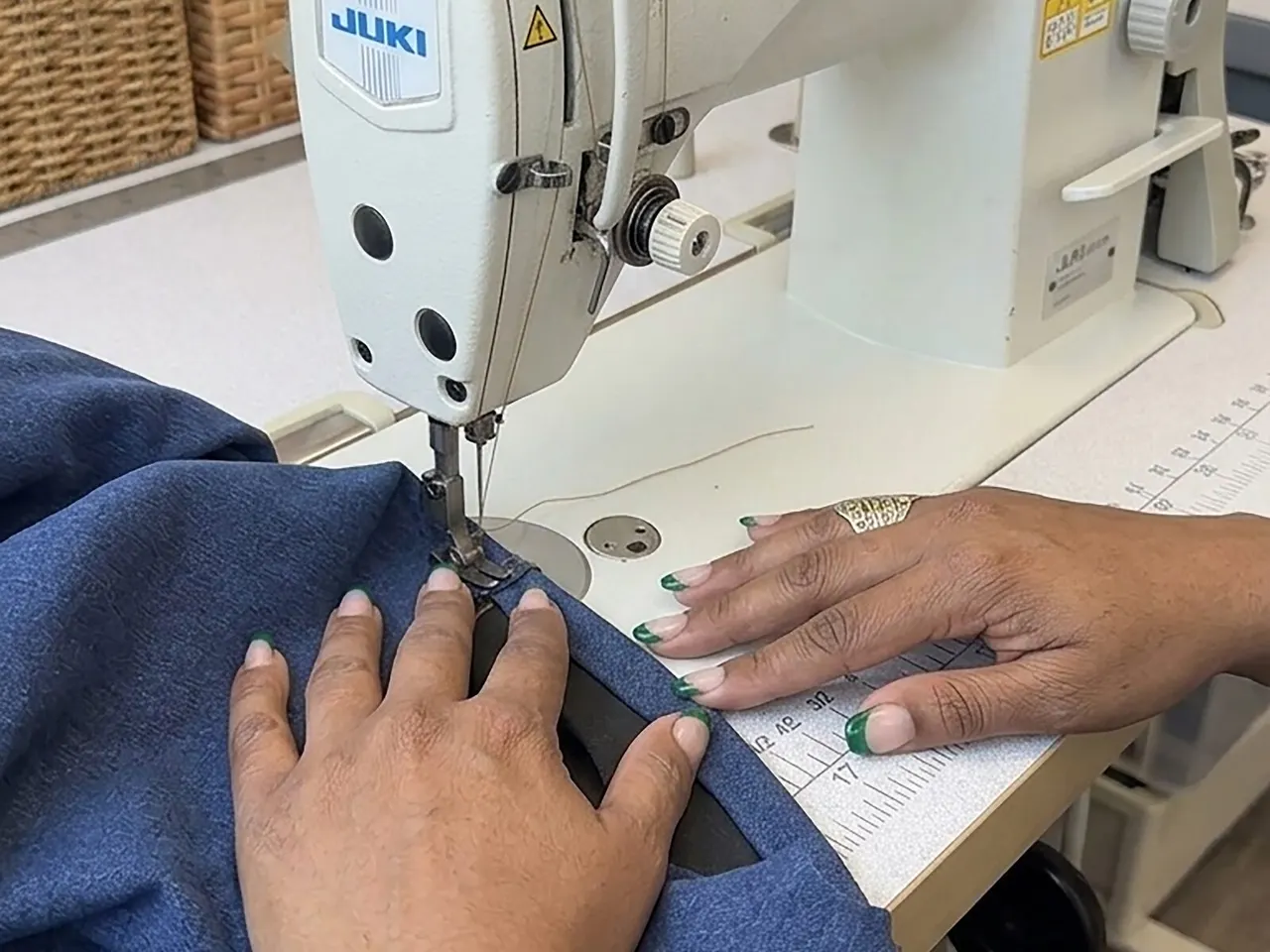 Our tailor sewing a garment at Jasmin Express in Barnet